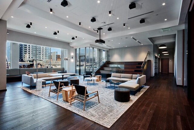 living room featuring dark hardwood / wood-style floors and a tray ceiling