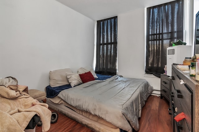 bedroom featuring dark hardwood / wood-style flooring and a baseboard radiator