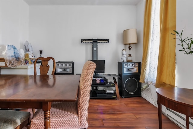 dining space featuring a baseboard radiator and dark wood-type flooring