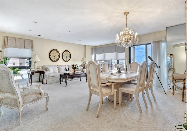 carpeted dining space featuring an inviting chandelier