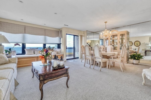 carpeted living room featuring a notable chandelier