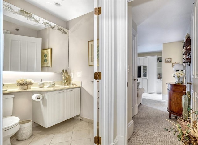 bathroom featuring tile patterned flooring, vanity, and toilet