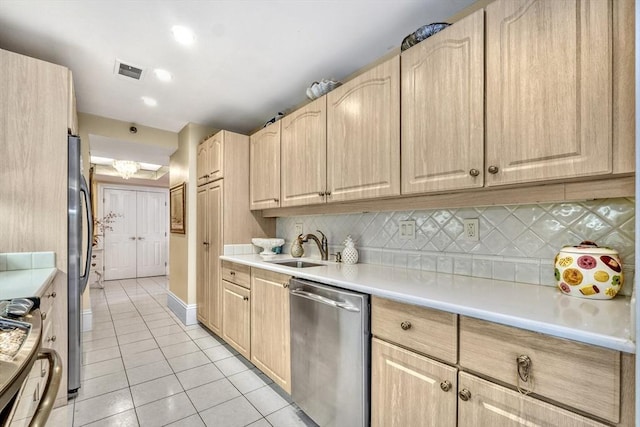 kitchen featuring decorative backsplash, appliances with stainless steel finishes, light brown cabinetry, sink, and light tile patterned floors