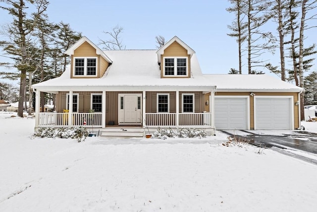 cape cod home with a garage and covered porch