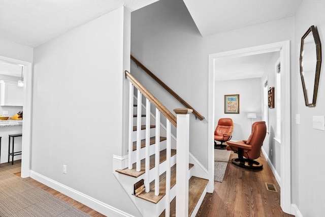 stairway featuring hardwood / wood-style floors