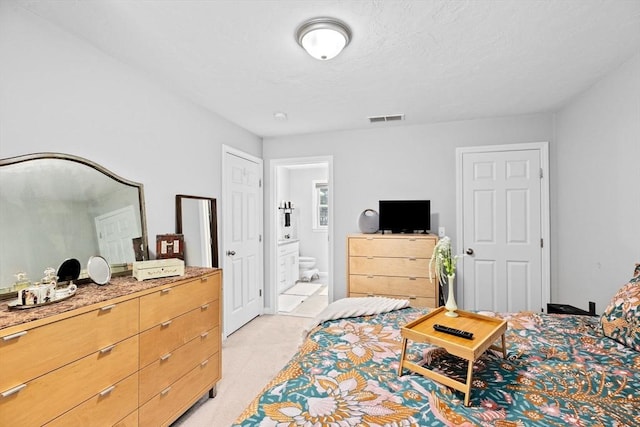 carpeted bedroom featuring ensuite bathroom