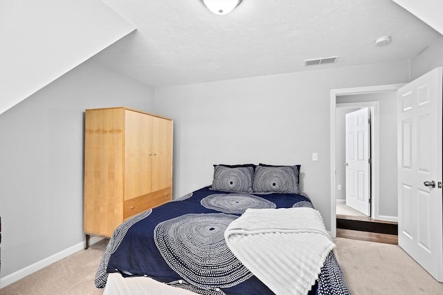 carpeted bedroom with lofted ceiling