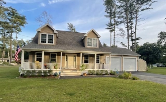 cape cod-style house featuring a garage, covered porch, and a front yard