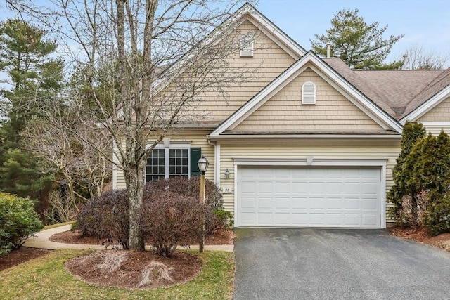 31 Fox Holw, Plymouth, MA 02360 - view of front facade with asphalt driveway, roof with shingles, and an attached garage
