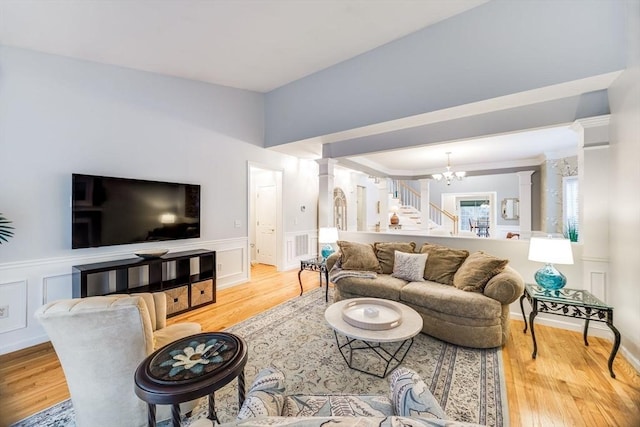 31 Fox Holw, Plymouth, MA 02360 - living room featuring a decorative wall, a chandelier, light wood-type flooring, stairs, and a wainscoted wall