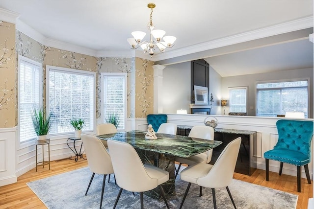 31 Fox Holw, Plymouth, MA 02360 - dining room featuring a chandelier, plenty of natural light, ornamental molding, wood finished floors, and a wainscoted wall