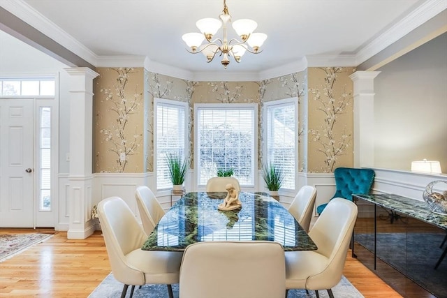 31 Fox Holw, Plymouth, MA 02360 - dining room featuring a chandelier, a decorative wall, wood finished floors, a wainscoted wall, and ornamental molding