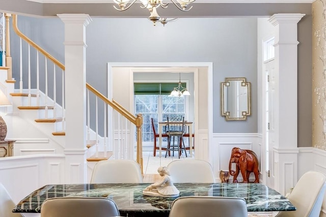 31 Fox Holw, Plymouth, MA 02360 - dining area with a chandelier, a decorative wall, stairway, a wainscoted wall, and ornate columns