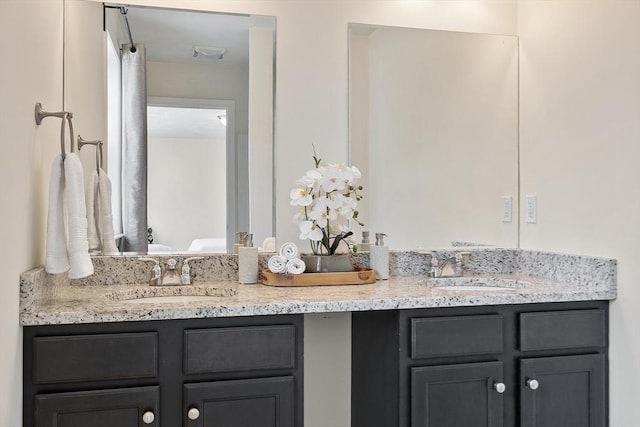 bathroom with a sink and double vanity
