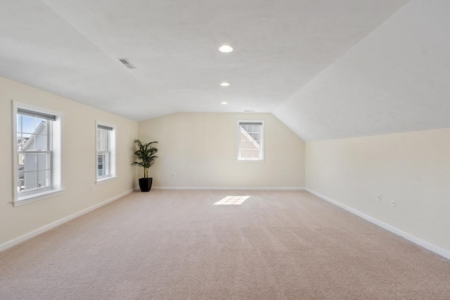 bonus room with lofted ceiling and baseboards