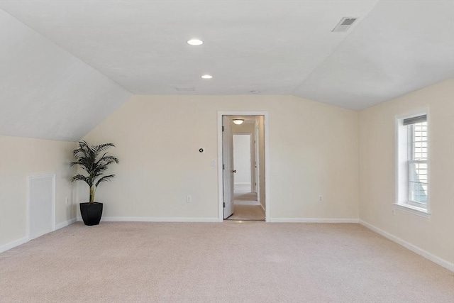 bonus room featuring vaulted ceiling, baseboards, and light colored carpet