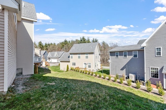 view of yard featuring ac unit and a residential view
