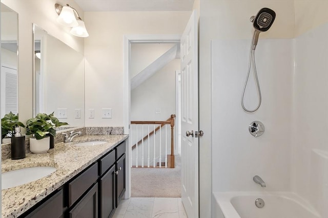 bathroom featuring marble finish floor, shower / washtub combination, a sink, and double vanity