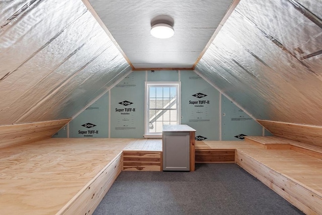 bonus room with lofted ceiling and carpet