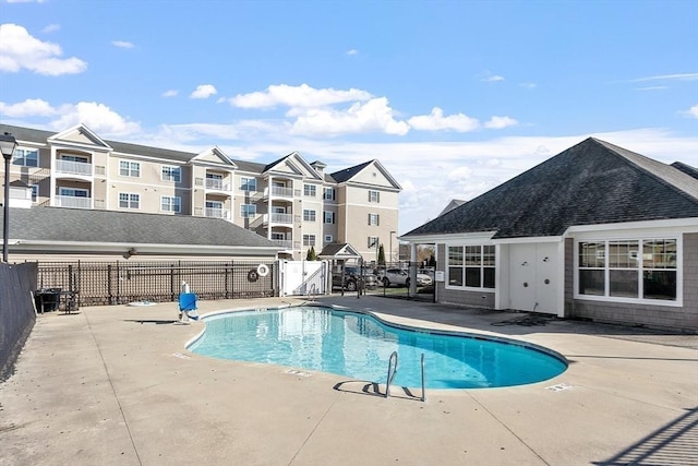 pool with fence, a patio area, and a gate