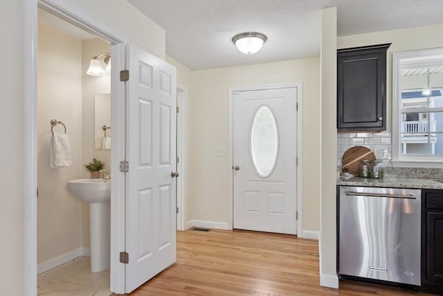 entrance foyer featuring baseboards and light wood finished floors