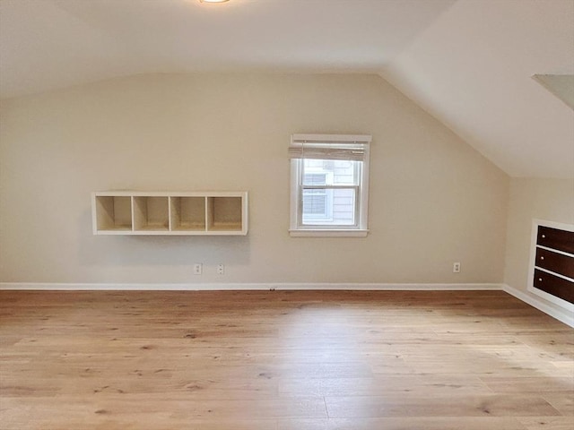 bonus room with light hardwood / wood-style floors and lofted ceiling