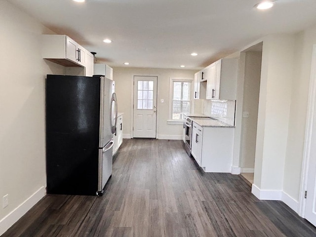 kitchen featuring tasteful backsplash, white cabinetry, dark hardwood / wood-style floors, and stainless steel appliances