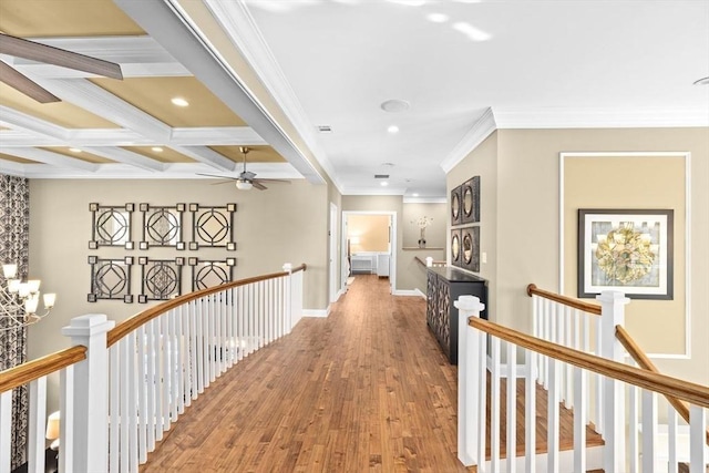 hallway featuring an upstairs landing, coffered ceiling, and wood finished floors