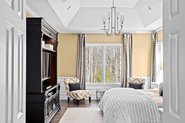 bedroom featuring dark wood finished floors, an inviting chandelier, a tray ceiling, and vaulted ceiling