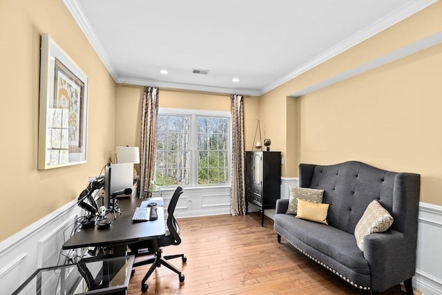 office with visible vents, a wainscoted wall, ornamental molding, recessed lighting, and wood finished floors