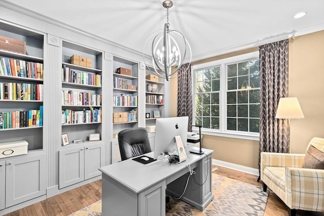 office area featuring light wood-type flooring, baseboards, an inviting chandelier, and ornamental molding