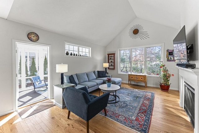 living room with light hardwood / wood-style floors and lofted ceiling