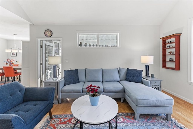 living room with vaulted ceiling and hardwood / wood-style floors