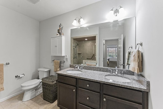 bathroom featuring toilet, vanity, an enclosed shower, and tile patterned floors