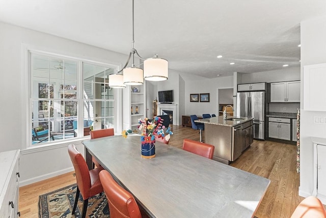 dining area featuring a wealth of natural light, light hardwood / wood-style floors, and sink