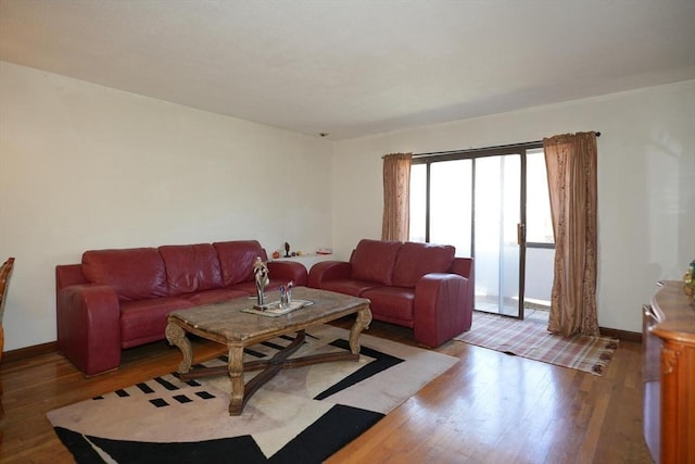 living area featuring baseboards and wood finished floors