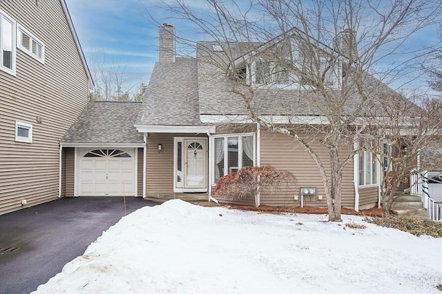 cape cod-style house with a garage