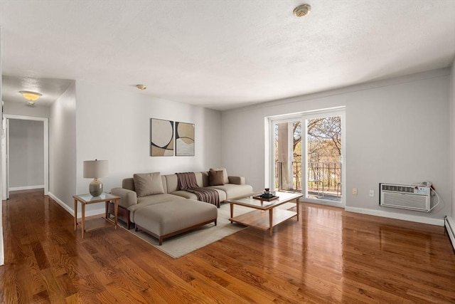 living room featuring baseboards, a wall mounted AC, and wood finished floors