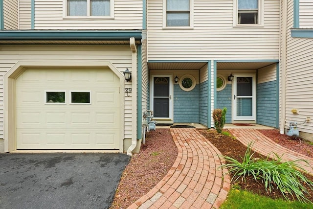 29 Crystal Brook Way Unit C, Marlborough, MA 01752 - view of exterior entry with an attached garage, covered porch, and asphalt driveway
