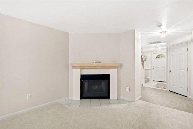 29 Crystal Brook Way Unit C, Marlborough, MA 01752 - unfurnished living room featuring carpet floors, a fireplace with flush hearth, and tile patterned flooring