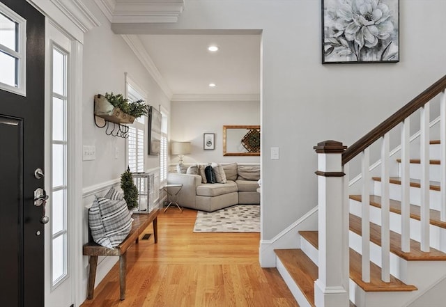 entrance foyer featuring light wood finished floors, recessed lighting, stairs, and ornamental molding