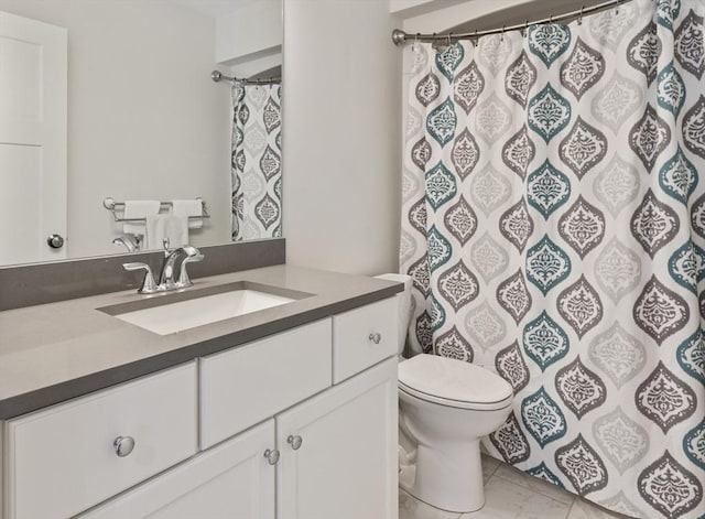 bathroom featuring toilet, vanity, and a shower with curtain