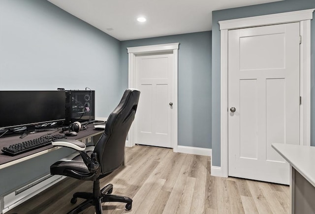 office space with recessed lighting, light wood-style flooring, and baseboards