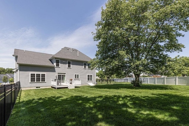 back of property featuring a shingled roof, a yard, a fenced backyard, and a wooden deck