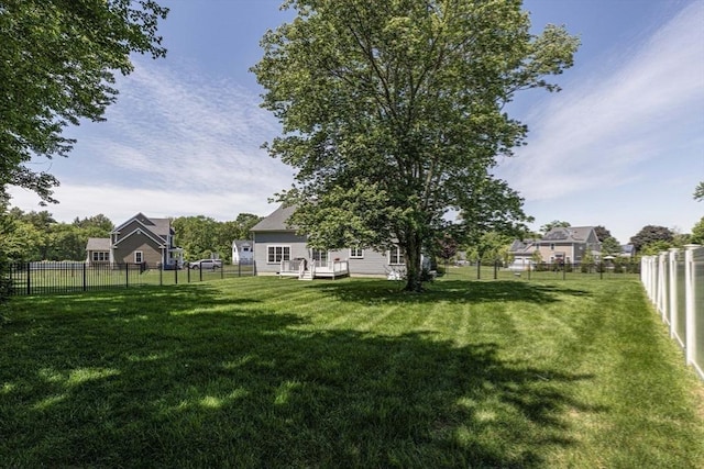 view of yard featuring a deck and a fenced backyard