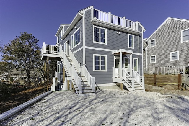 rear view of property featuring a balcony