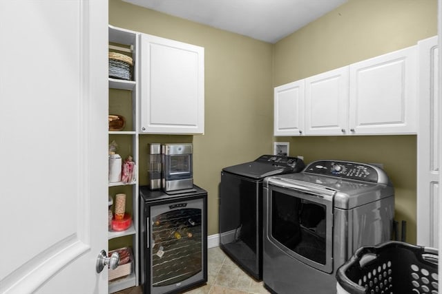 laundry room with cabinets, light tile patterned floors, separate washer and dryer, and beverage cooler