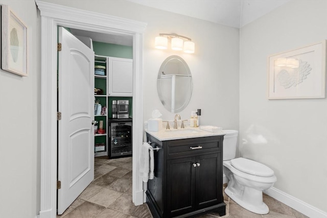 bathroom featuring vanity, toilet, and beverage cooler