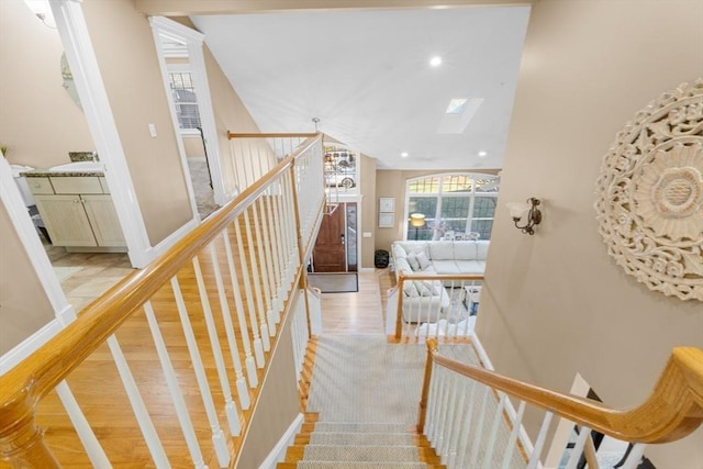 staircase featuring hardwood / wood-style flooring and a skylight