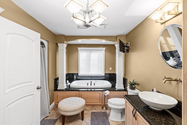 bathroom with a washtub, an inviting chandelier, tile patterned flooring, toilet, and vanity